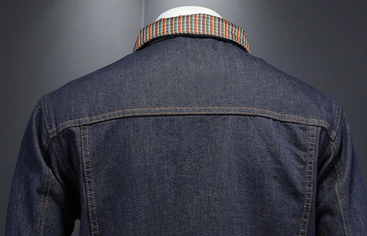 Dark blue denim jacket back and hem detail with plaid-lined collar and front pockets