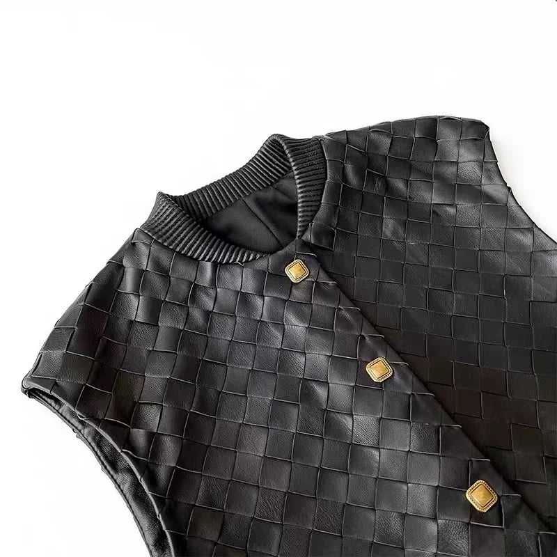 Black knitted leather-look vest close-up, grid weave and gold buckle detail