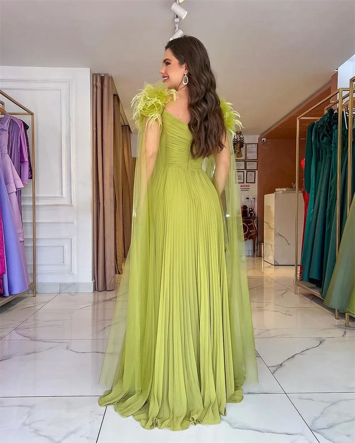 Light green formal gown in side view with V-neck and feathered shoulder detail