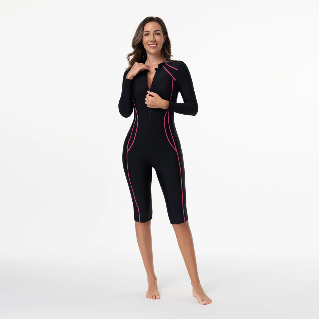 Black zip-front one-piece swimsuit with long sleeves, magenta piping and knee-length legs