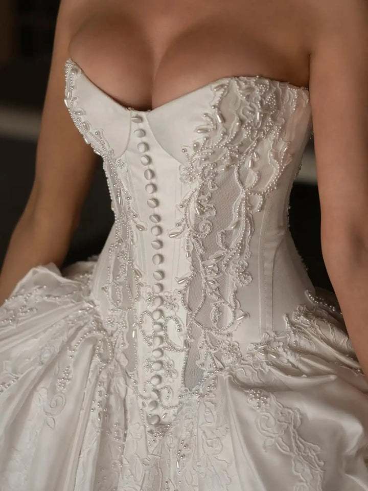 Ivory satin corset bodice with lace embroidery and button-style textured detailing