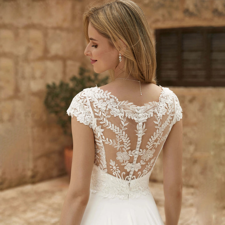 Floral lace chiffon bridal gown with sheer back and cap sleeves