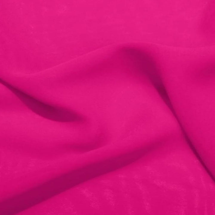 Fuchsia pink satin fabric close-up with soft drape