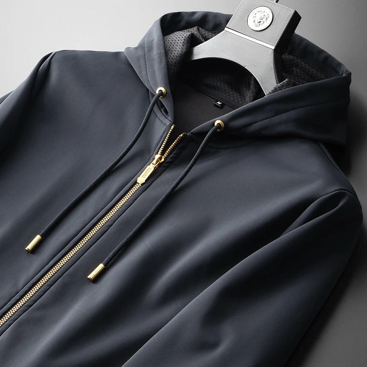 Navy men’s zip-up hoodie with drawstrings, gold zipper, and mesh-lined hood