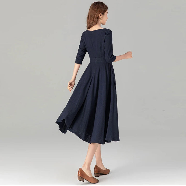 Dark blue midi dress back view with 3/4 sleeves and pleated A-line skirt