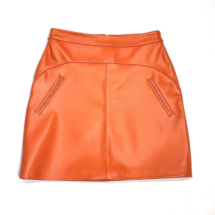 Orange high-waist leather mini skirt with front center seam and pocket zippers