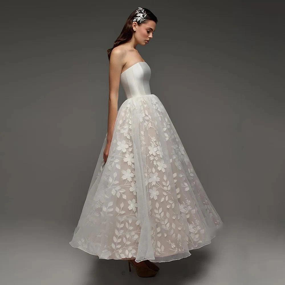 Strapless bridal gown side view with ivory satin bodice and floral lace tulle skirt
