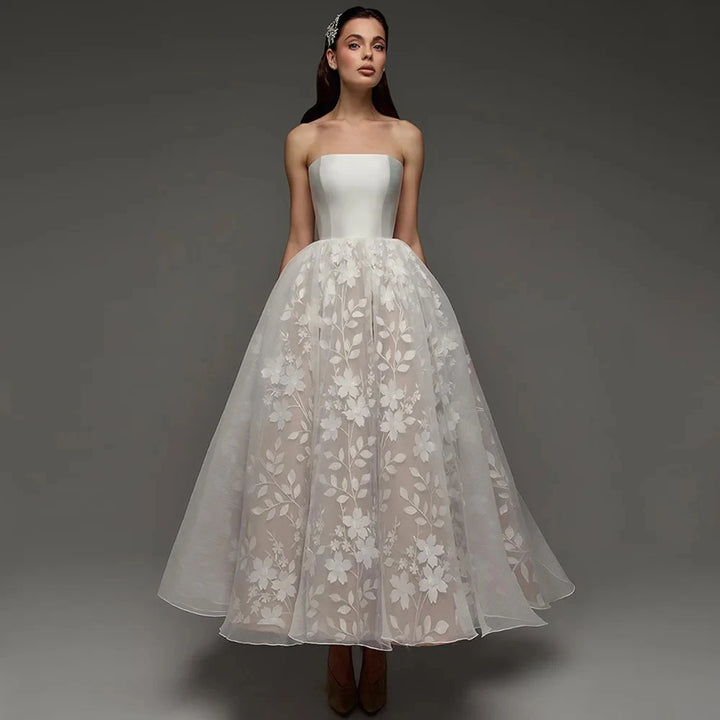 Strapless bridal gown with ivory satin bodice and floral lace tulle skirt, full length