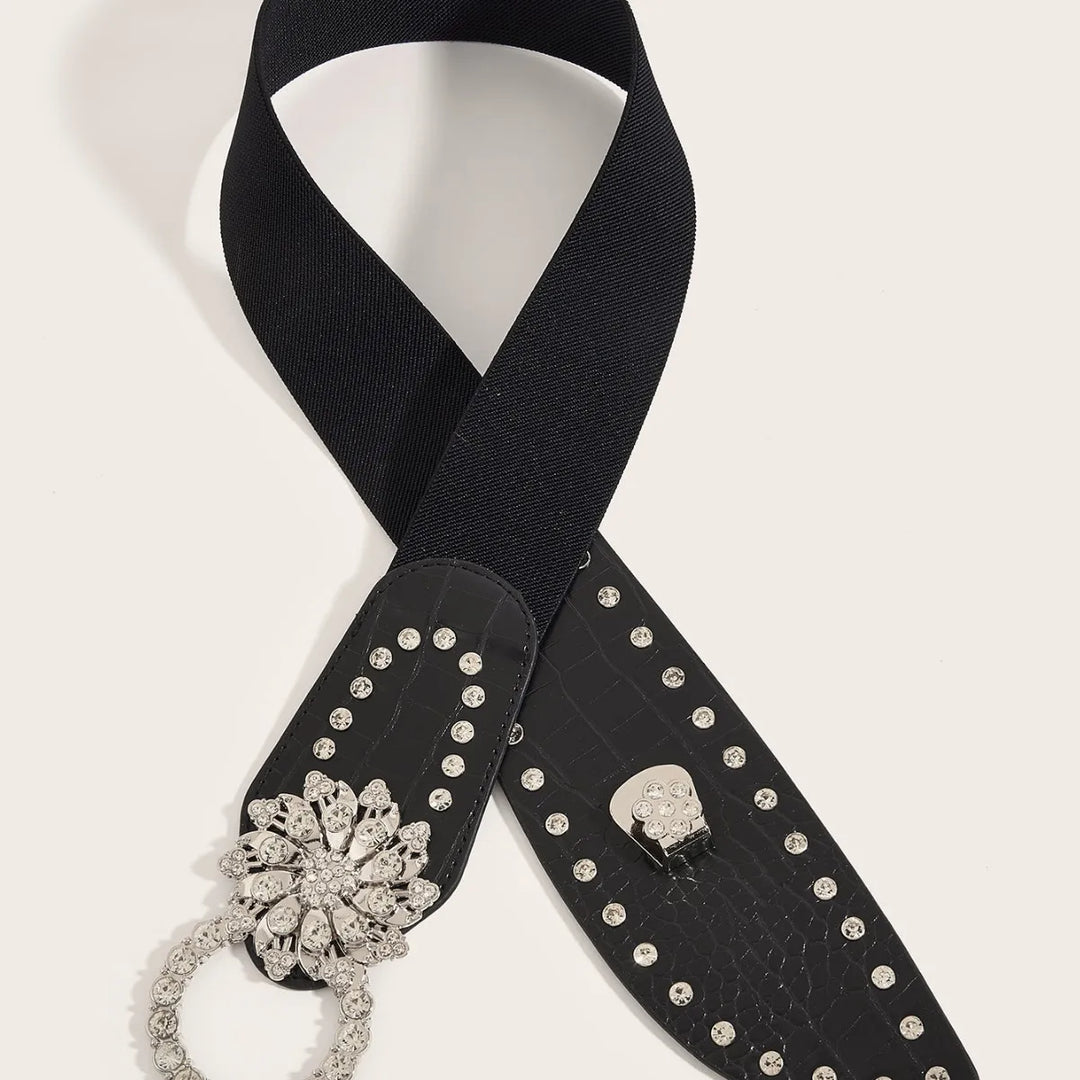 Black PU corset belt with rhinestone floral buckle at end and studded strap