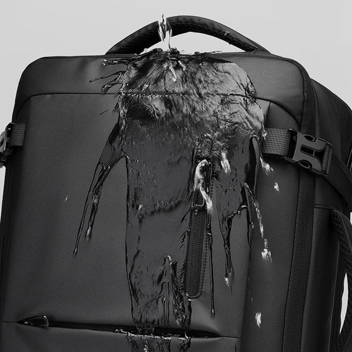 Black travel backpack with water-resistant, sealed-looking top panel and front strap