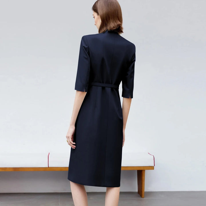 Back view of knee-length navy skirt suit dress with waist belt and 3/4 sleeves