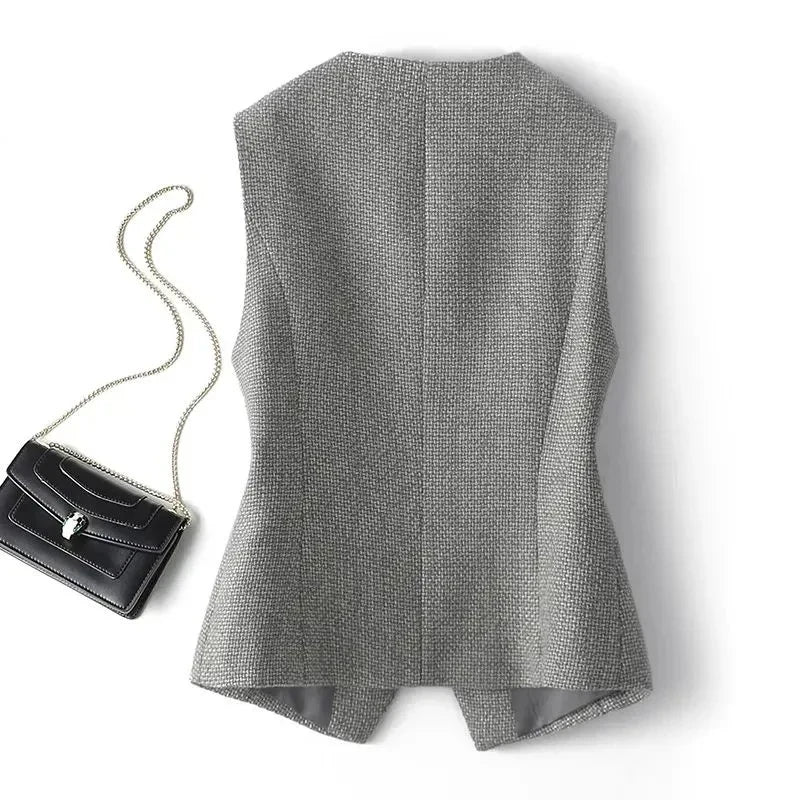 Grey sleeveless waistcoat back view with textured woven fabric and hem split