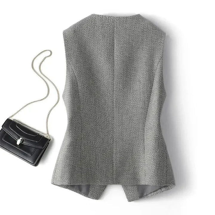 Grey sleeveless waistcoat back view with textured woven fabric and hem split