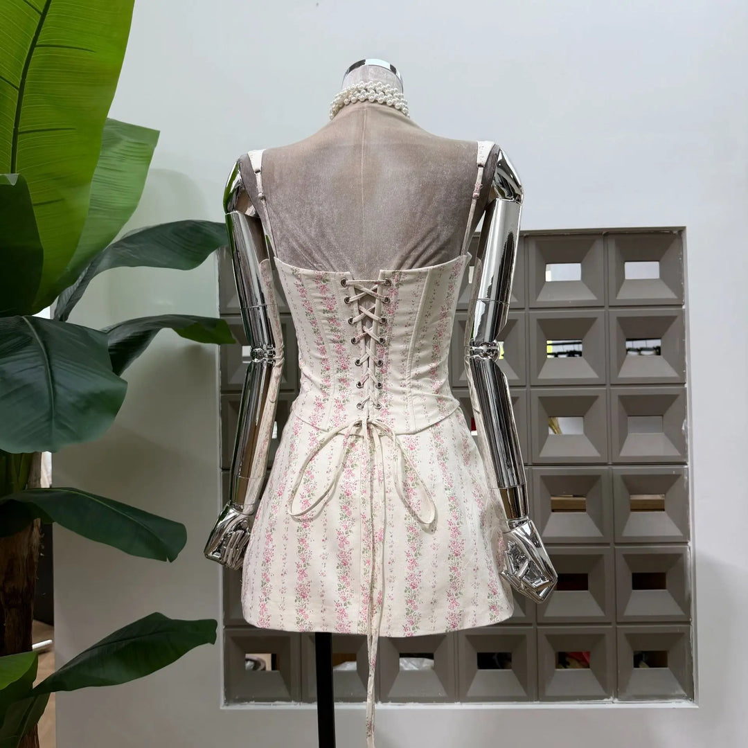 Back view of pink floral print mini skirt set with lace-up corset and waist ties