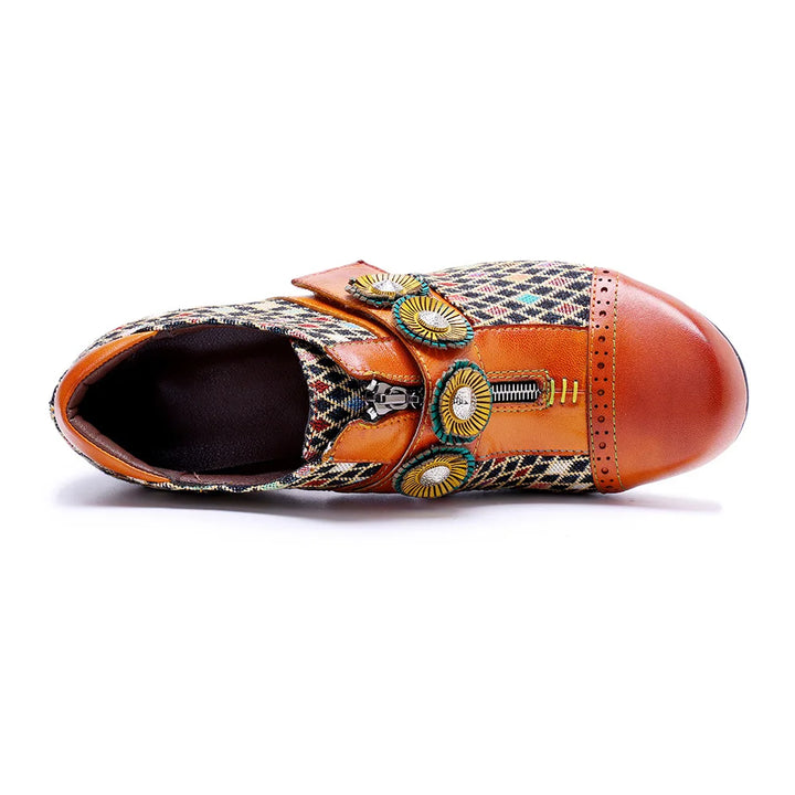 Orange leather slingback shoe with side closure, multicolor woven lining, and medallion strap