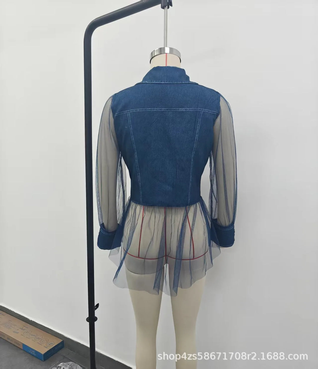 Blue denim patchwork blouse back on hanger with gathered peplum hem