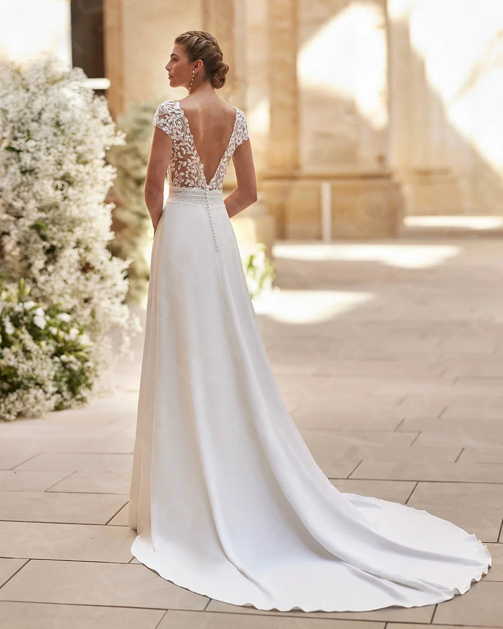 Ivory lace bridal gown, open back and cap sleeves, long skirt with front thigh slit