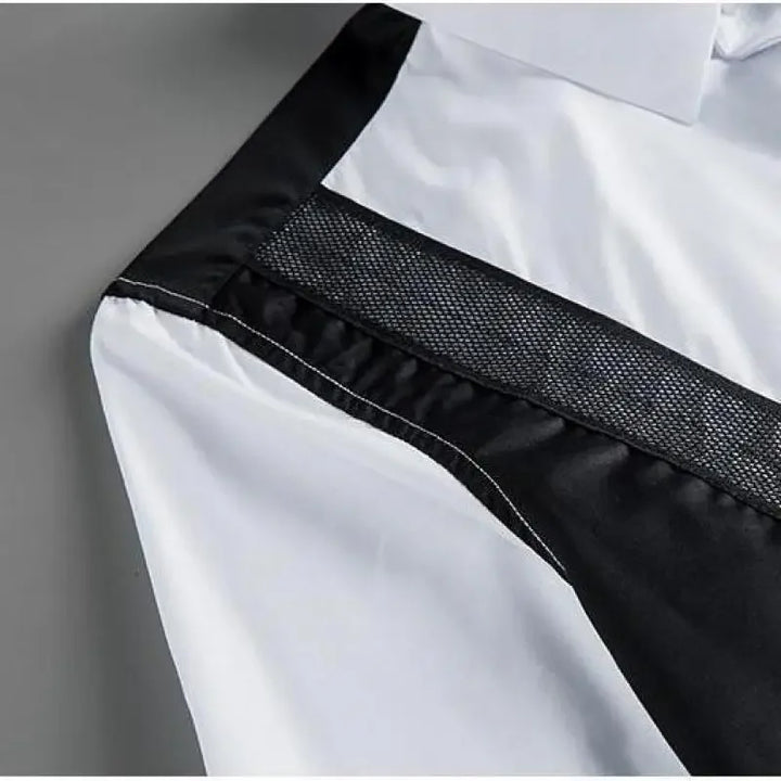 White button-up shirt with textured black mesh panel and contrast trim along shoulder