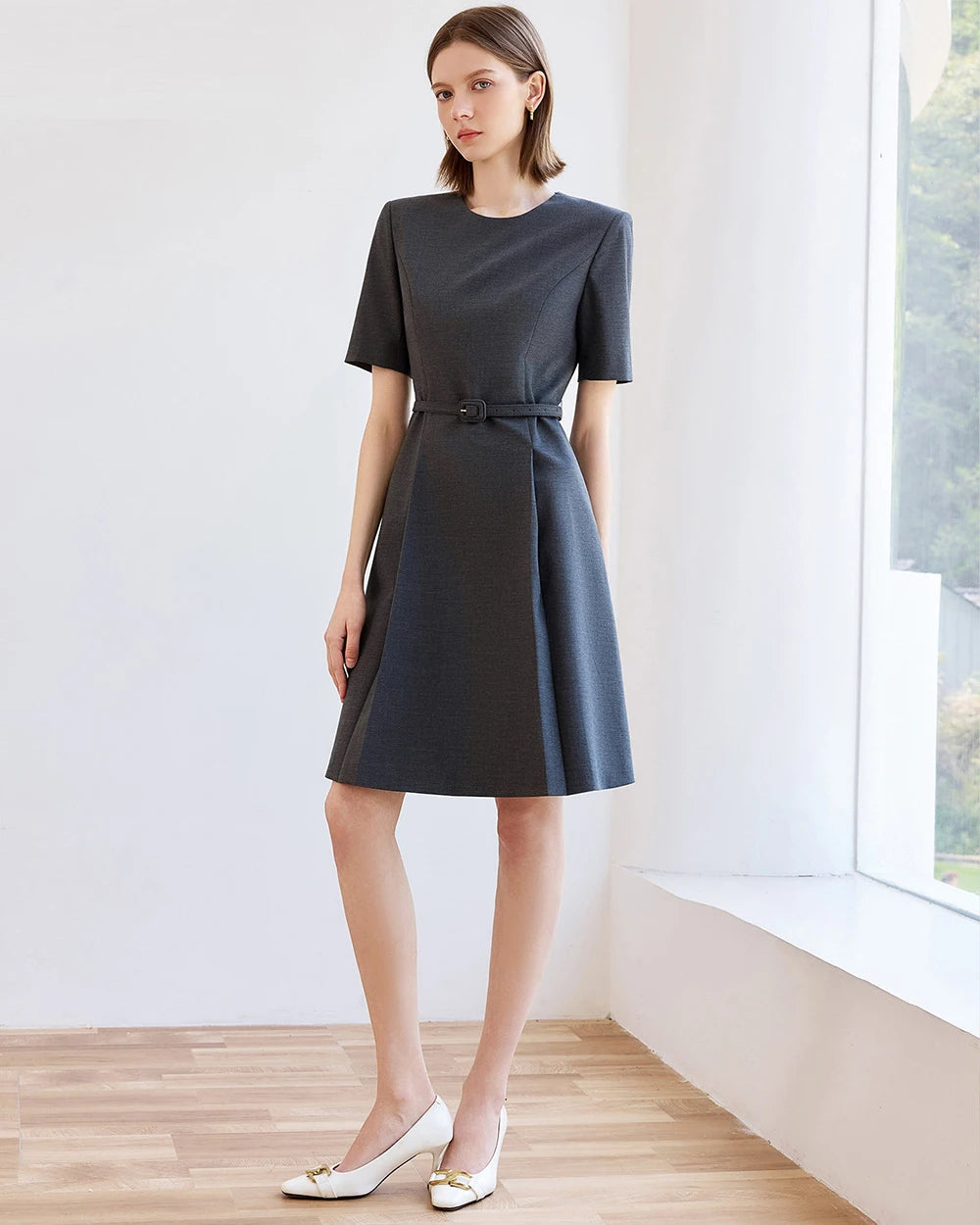 Dark short-sleeve A-line office dress with waist belt and knee-length skirt