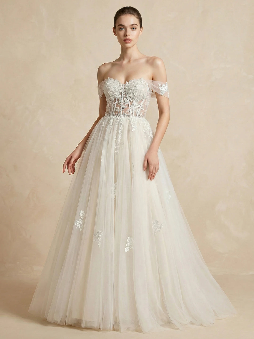 White mesh bridal dress with off-shoulder lace bodice and long tulle skirt train