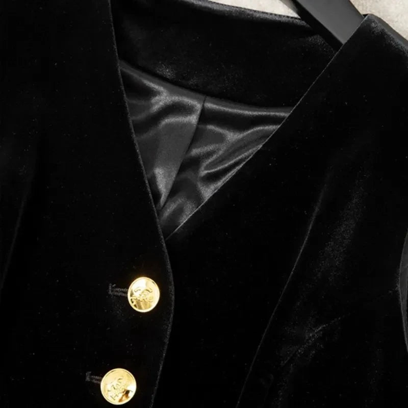 Black velvet waistcoat close-up showing V-neck lining and gold buttons