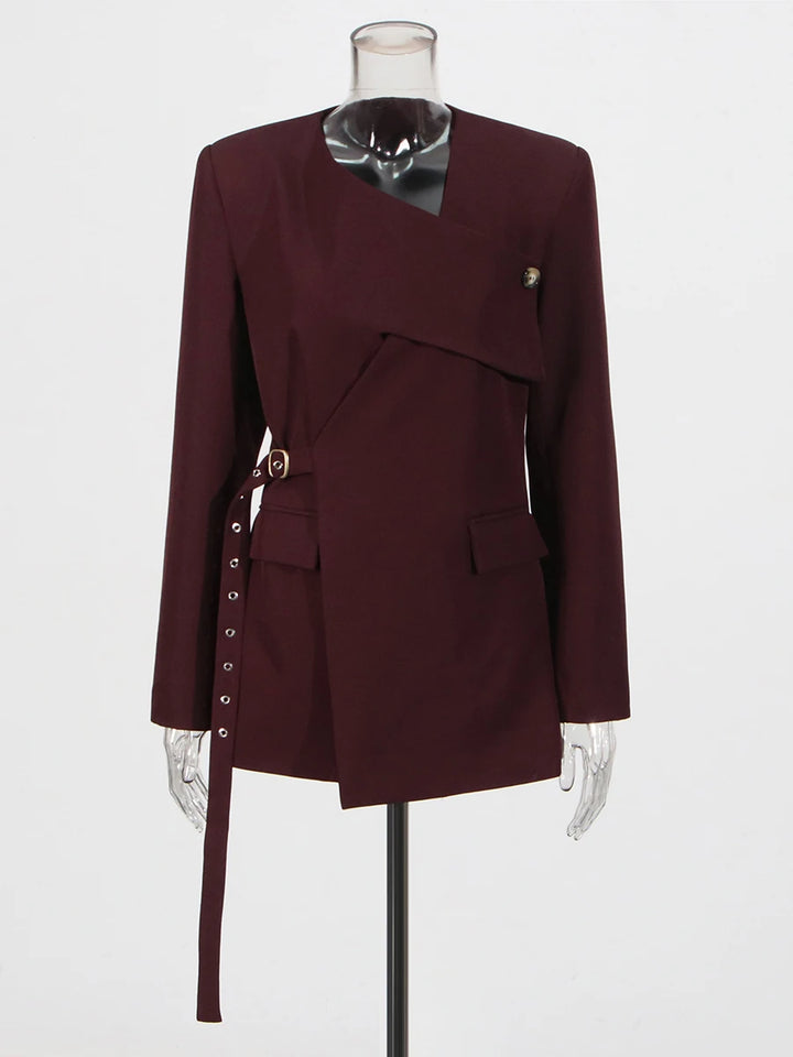 Burgundy asymmetrical blazer on mannequin with front buttons and waist tie