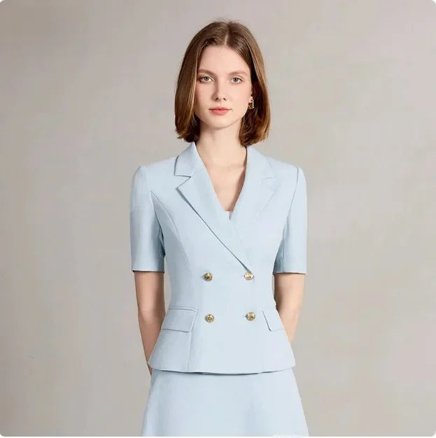 Front close-up of light blue blazer and midi skirt suit with gold buttons and lapels