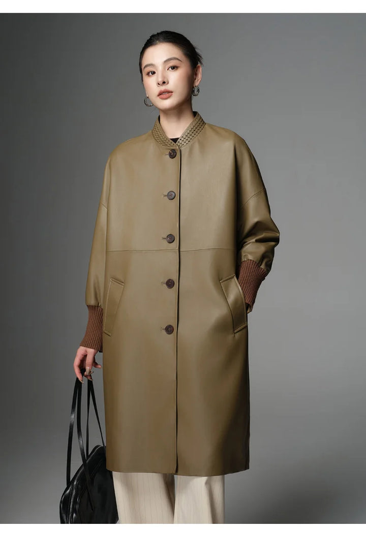 Women’s olive sheepskin coat with dark button closure, textured stand collar, side bag