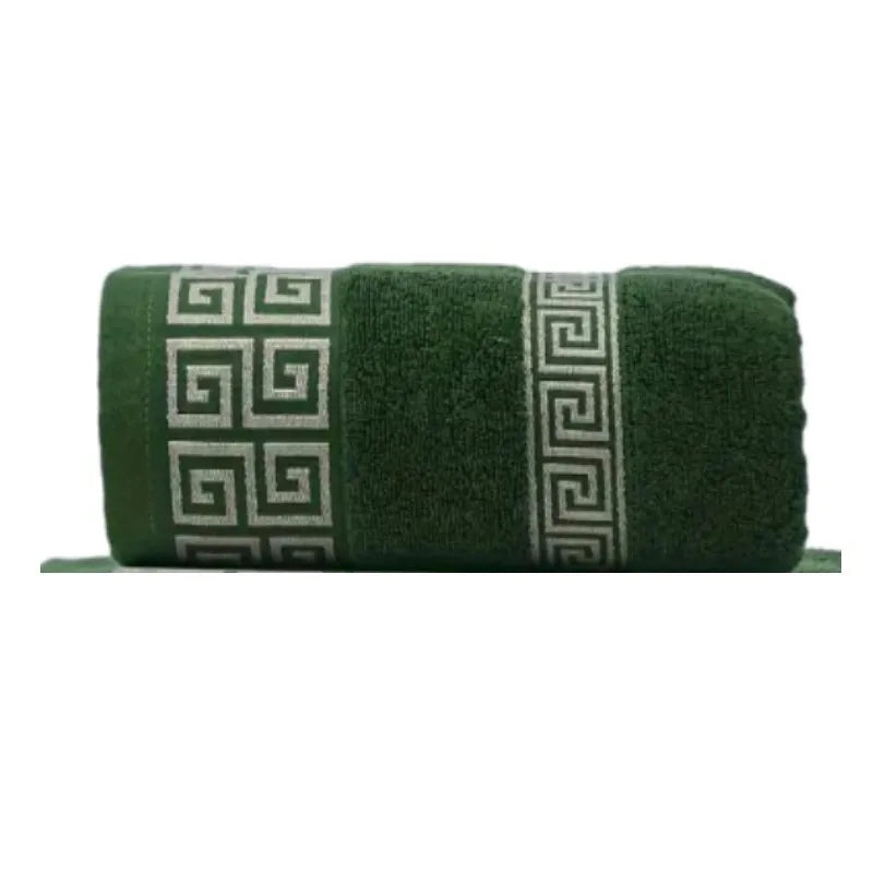 Cotton bathroom towel set in deep green with woven Greek border detail, rolled.