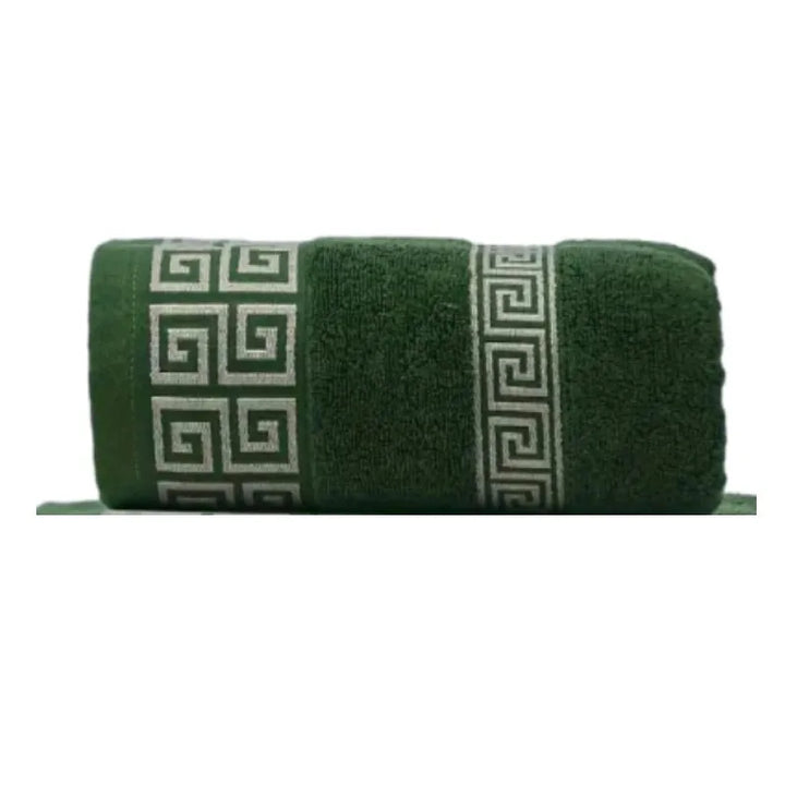 Cotton bathroom towel set in deep green with woven Greek border detail, rolled.