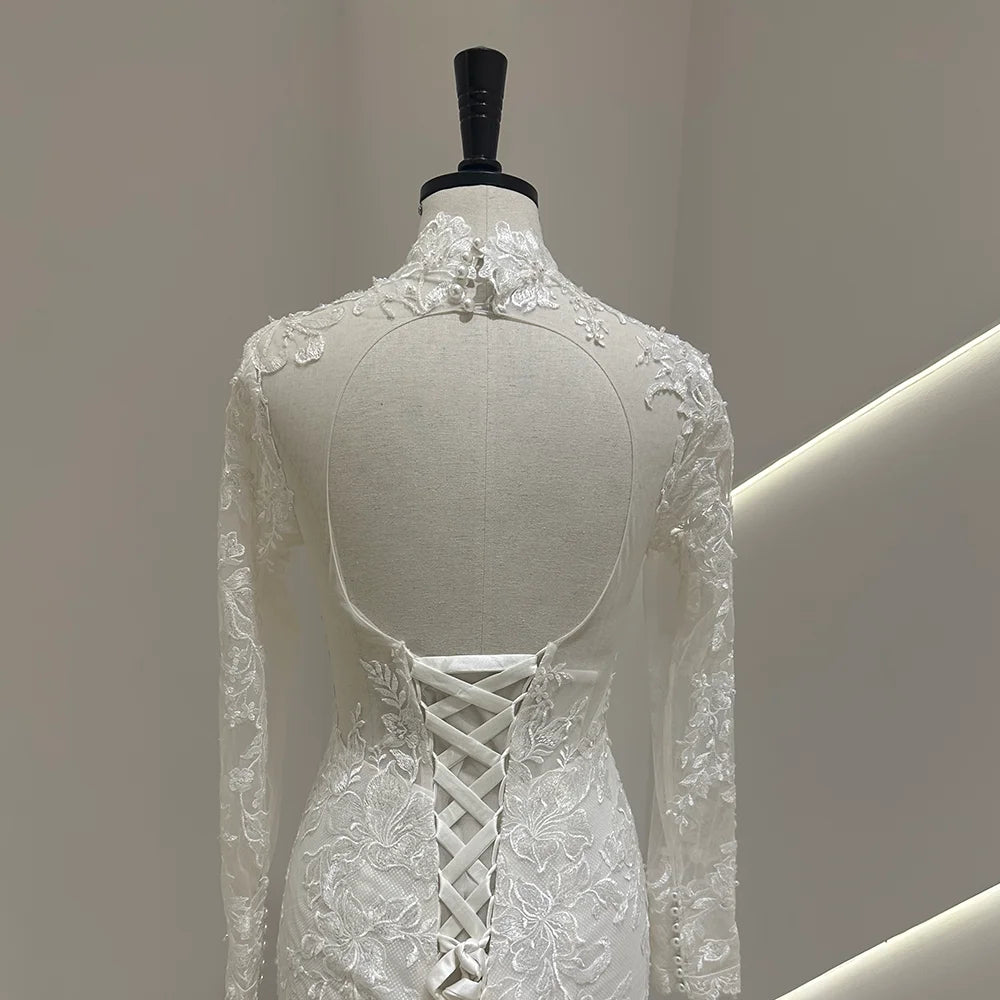 Ivory lace wedding gown back with crisscross lace-up corset and sheer long sleeves