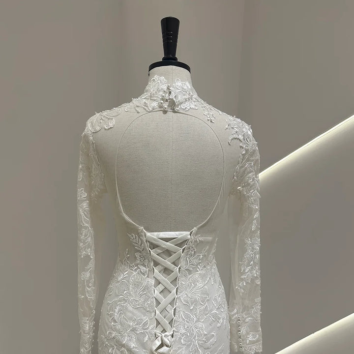 Ivory lace wedding gown back with crisscross lace-up corset and sheer long sleeves