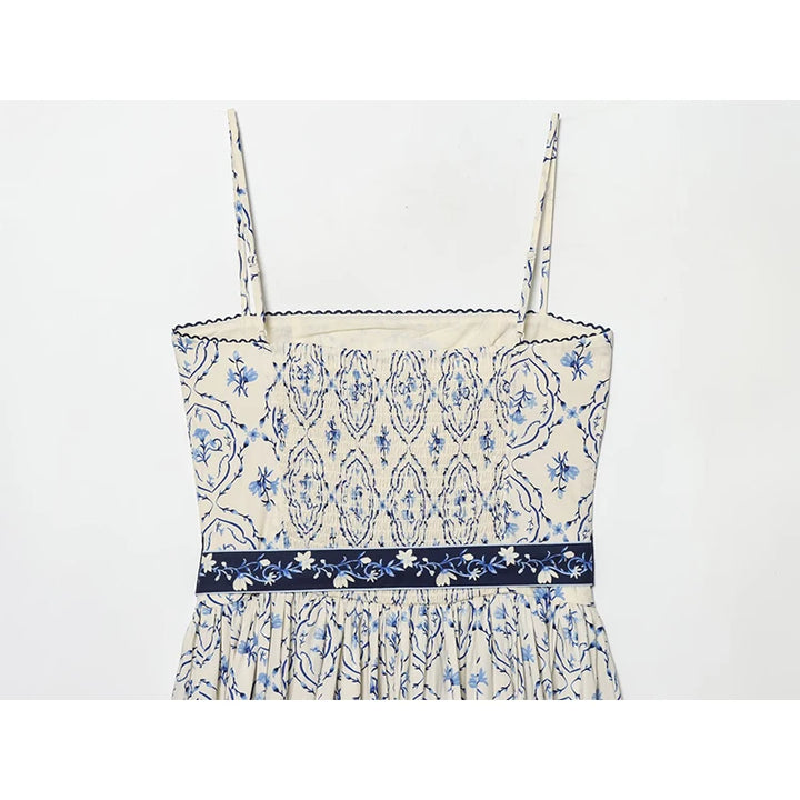 Front view floral print cami dress with navy sash belt, light base and blue detailing