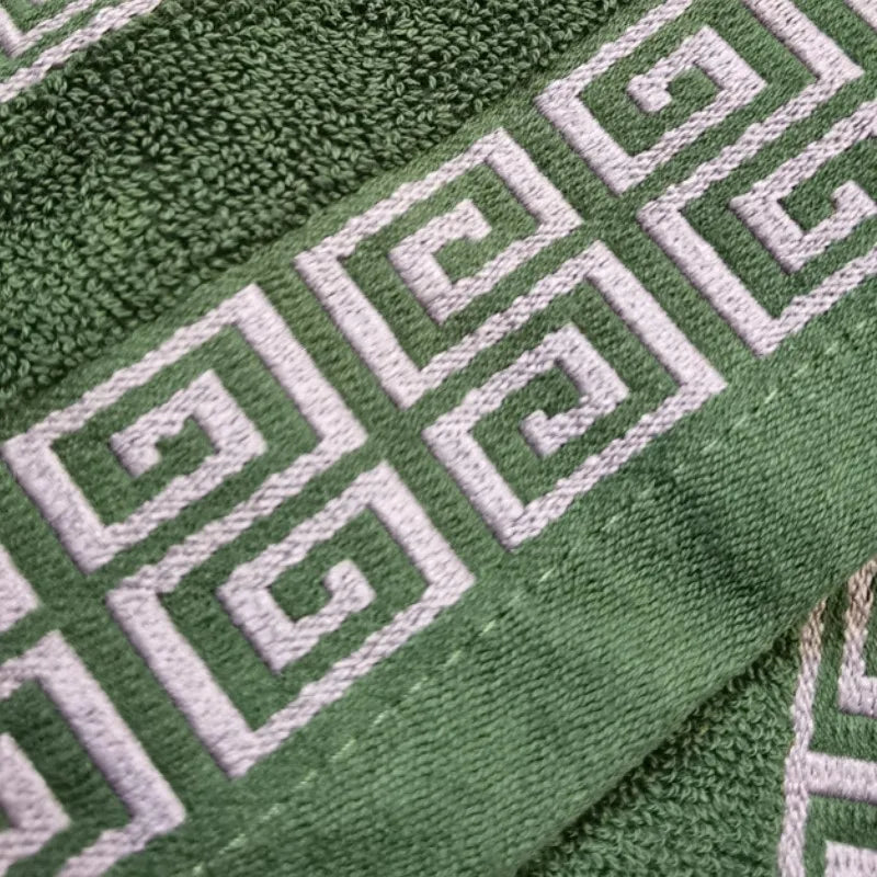 Green cotton hand towel with raised white Greek key embroidery band