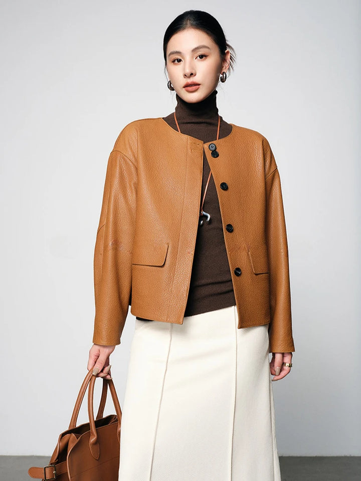 Ginger-brown leather short jacket with front snap buttons and chest pocket detail