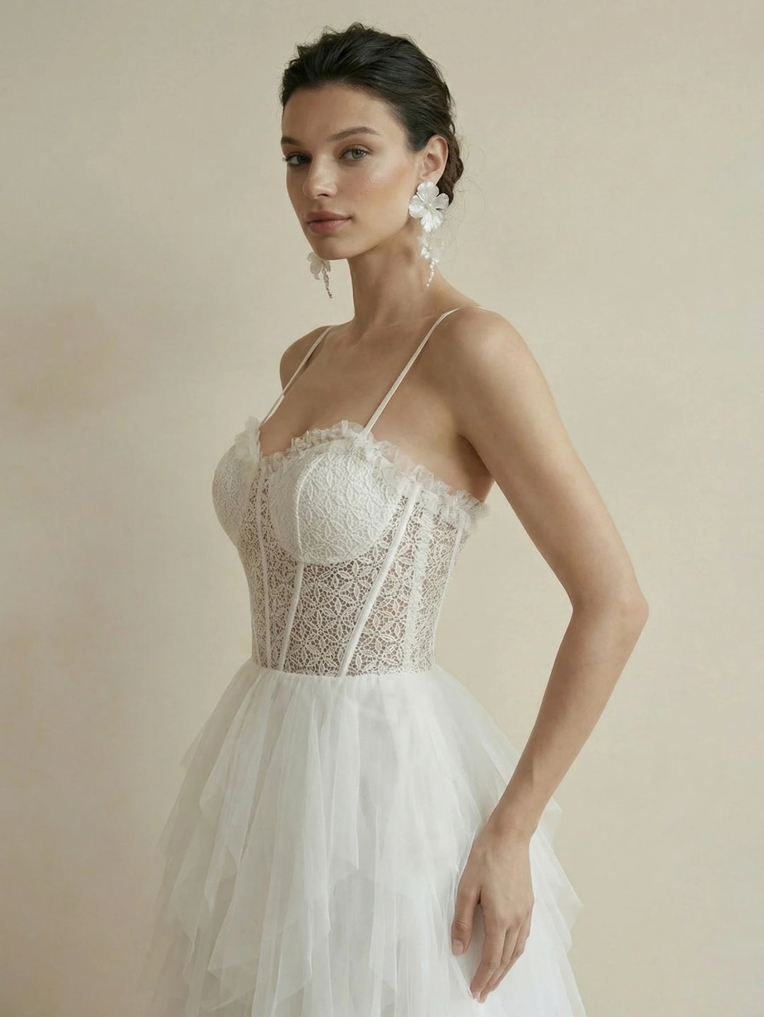 White tulle tiered ruffled bridal gown with sweetheart lace bodice and spaghetti straps