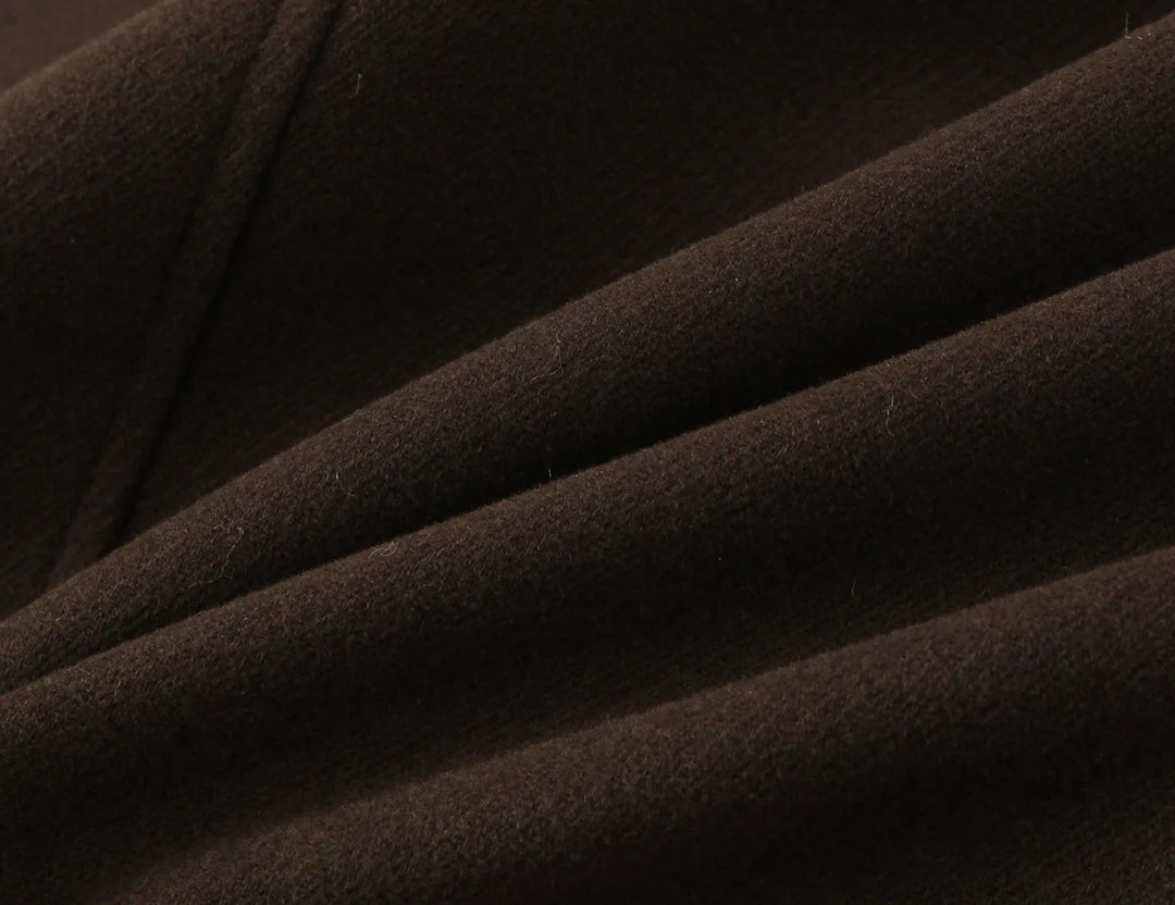 Brown short overcoat fabric close-up with smooth textured weave