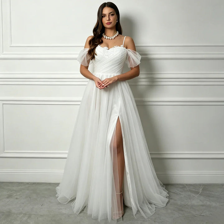 White A-line tulle bridal gown with sweetheart neckline, off-shoulder puff sleeves, front slit