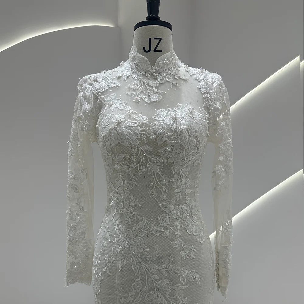Ivory lace high-neck wedding gown with floral bodice detailing and sheer lace sleeves