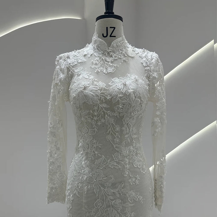 Ivory lace high-neck wedding gown with floral bodice detailing and sheer lace sleeves