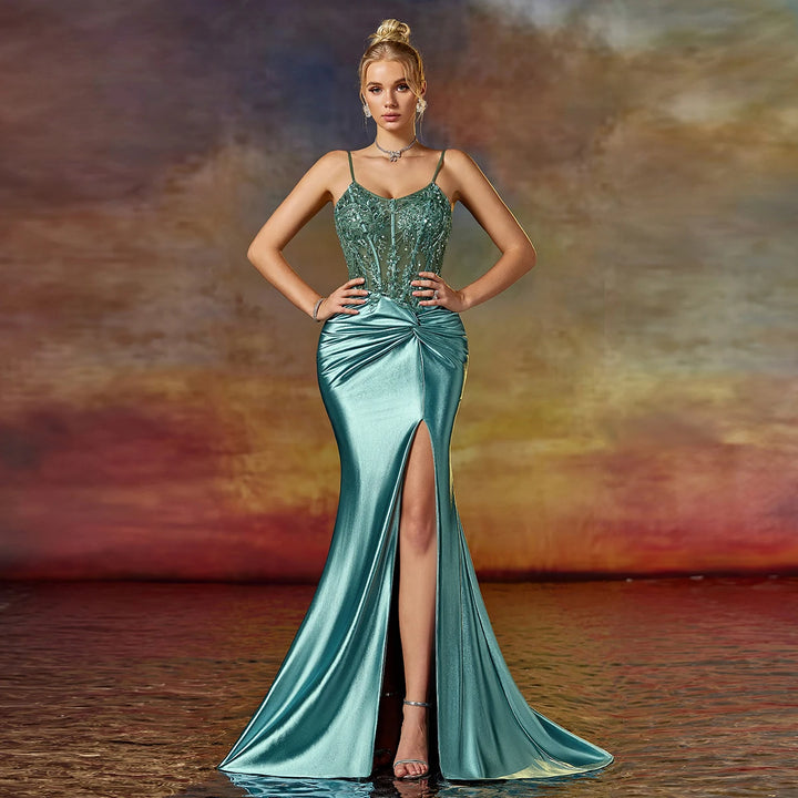Teal satin prom dress with beaded sequin bodice, spaghetti straps, ruched waist, slit.