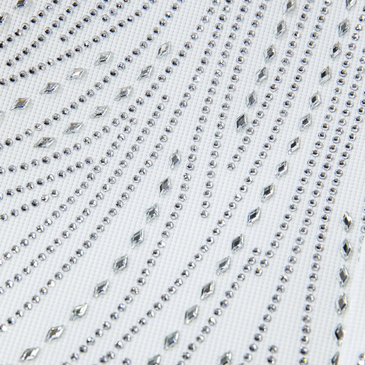 Close-up of white shirt chest with rhinestone dots and faceted stud lines