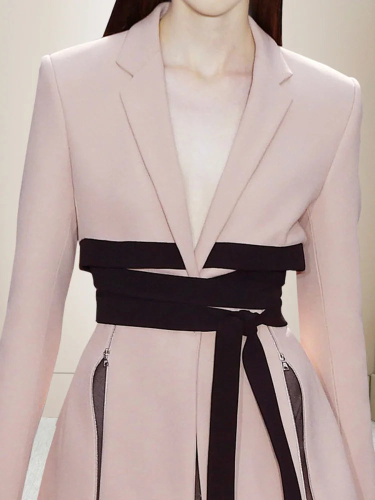 Women’s pink cropped blazer with deep V neckline and black waist tie detail