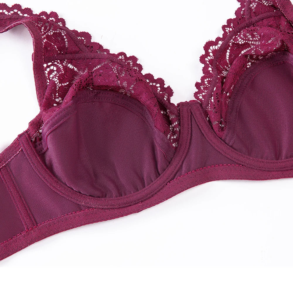 Close-up floral lace underwire bra in deep plum with scalloped cup edges and seam lines