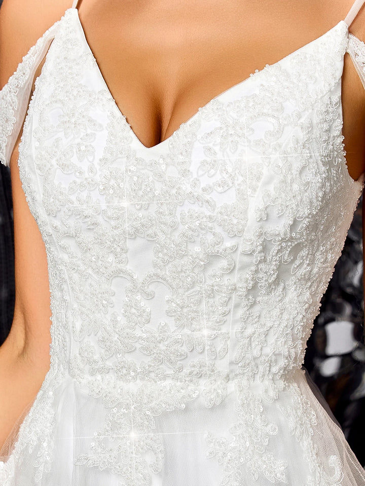 White off-shoulder beaded bridal gown with lace bodice and spaghetti straps