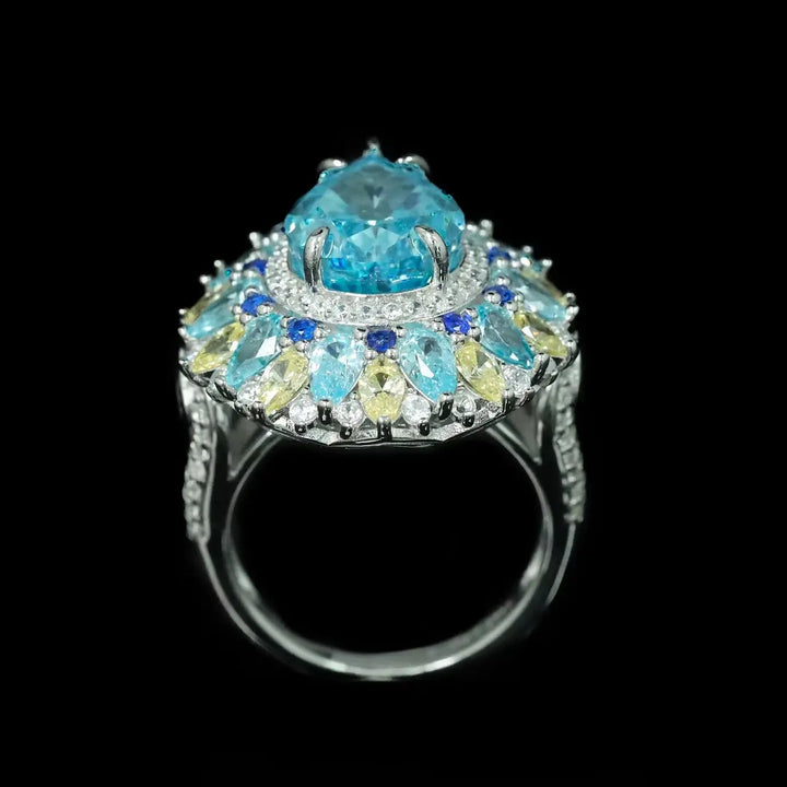 Aquamarine oval center ring with layered blue and light stones in silver