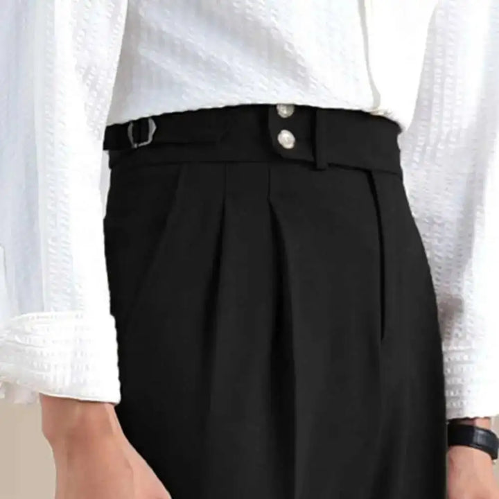Black linen-blend formal pants waistband close-up, button closure and pleats
