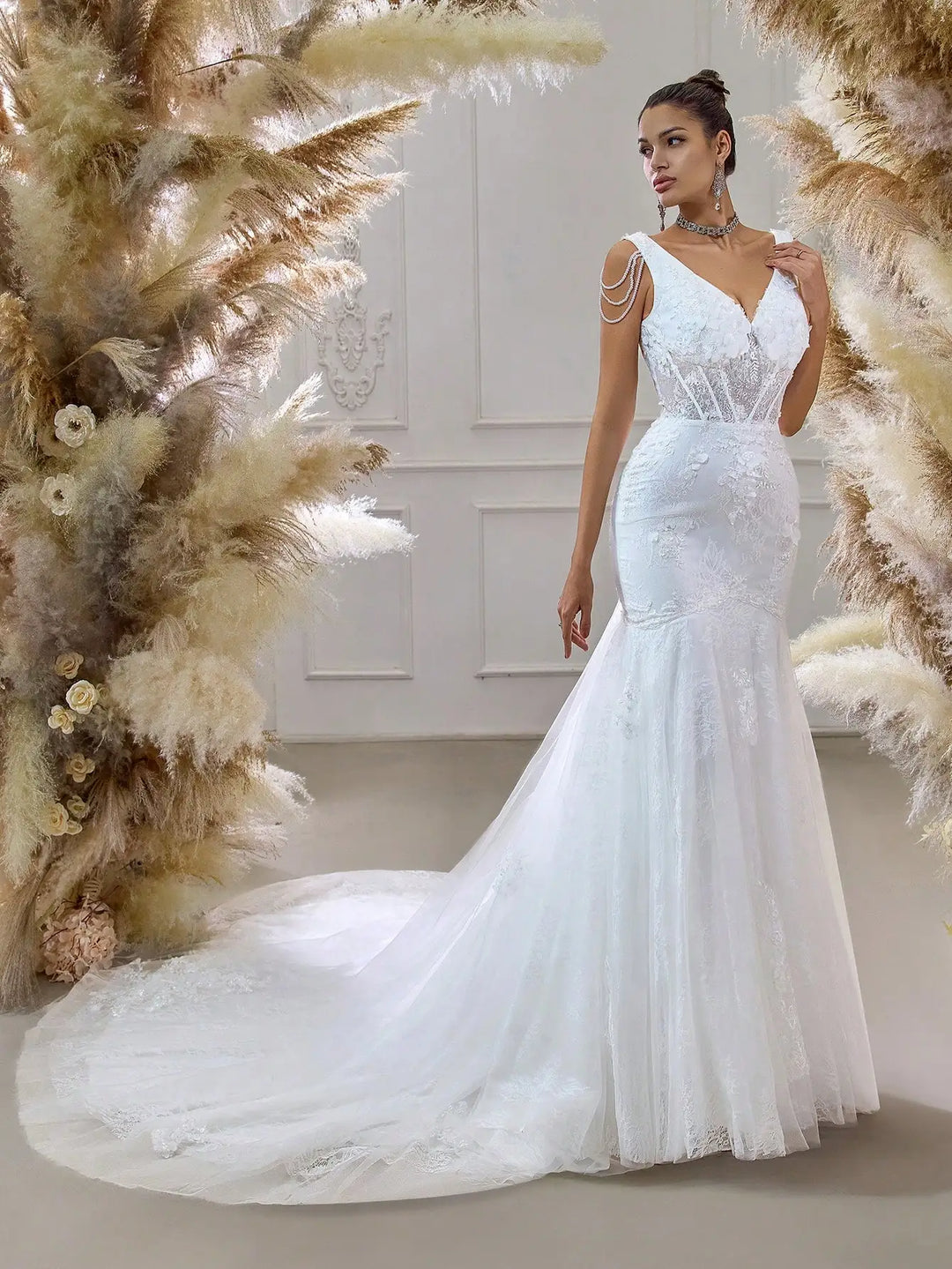 White beaded bridal mesh mermaid gown with thin shoulder straps and flowing train