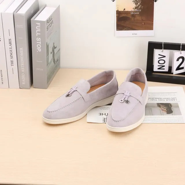 Light blue suede slip-on loafers with metal buckle and moc toe stitching