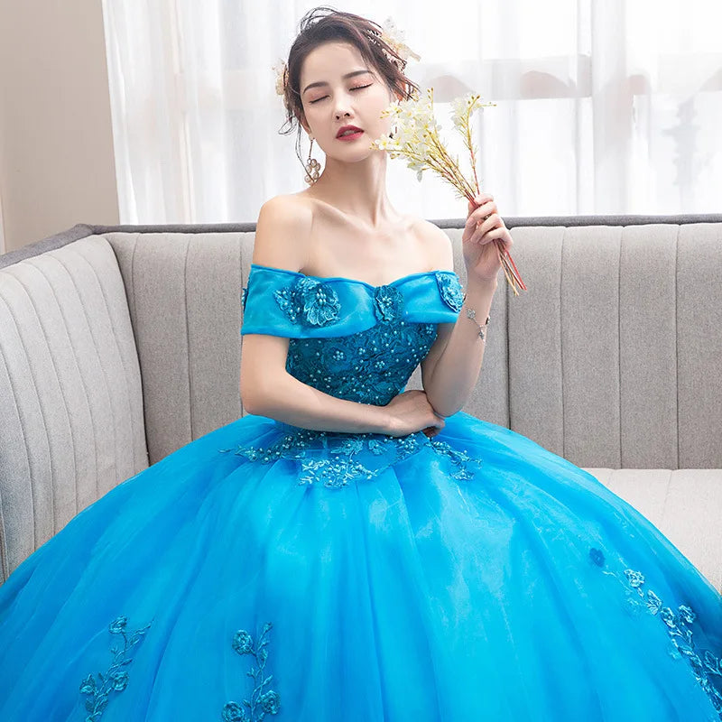 Lake blue off-shoulder party gown with embroidered floral details and full tulle skirt
